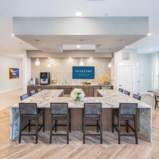 A modern kitchen with bar seating and elegant interior design.
