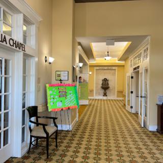A spacious hallway featuring a chamber entrance and decorative signage.