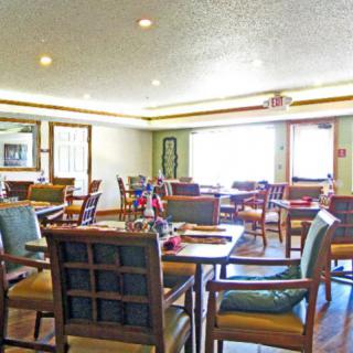 An empty dining area with neatly arranged tables and chairs.