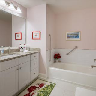 A beautifully designed bathroom featuring a bathtub, modern sink, and elegant decor.