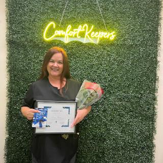 Celebrating an achievement with flowers and a certificate at the event.