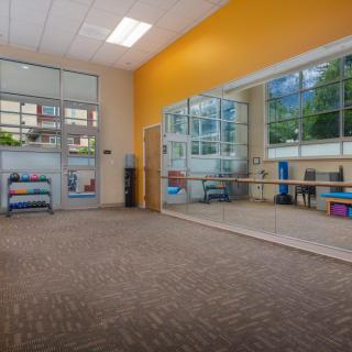 Spacious dance studio with large mirrors and natural lighting.