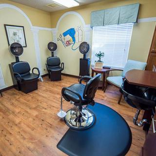 A cozy hair salon interior with styling chairs and hair dryers.