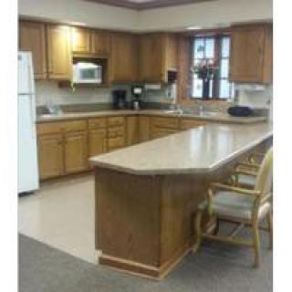 A kitchen with wooden cabinets and an island countertop.