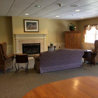 A cozy living room with a fireplace and comfortable seating.