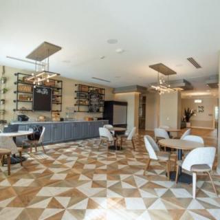 A modern dining area with contemporary furniture and elegant lighting.