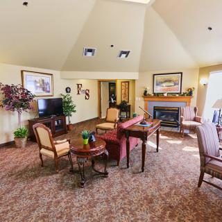 A cozy living room with comfortable seating, a fireplace, and decorative elements.