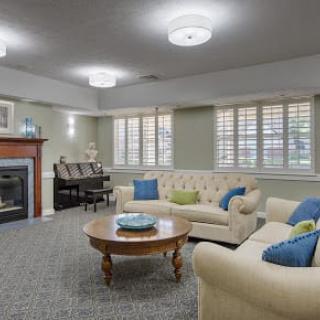 A cozy living room with comfortable sofas, a fireplace, and elegant decor.