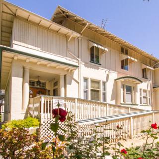 A charming residential house with a flower garden and sunny exterior.