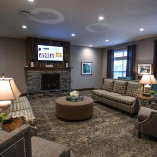 A cozy and modern living room with comfortable sofas, a fireplace, and stylish decor.