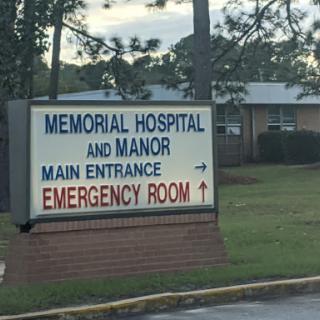 Sign directing to the emergency room of Memorial Hospital and Manor.