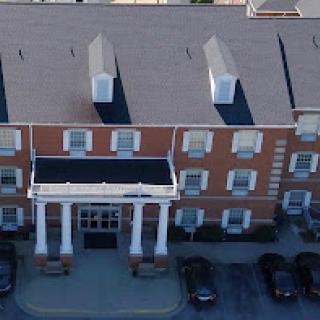 Aerial view of a brick hotel with a classic architectural design.