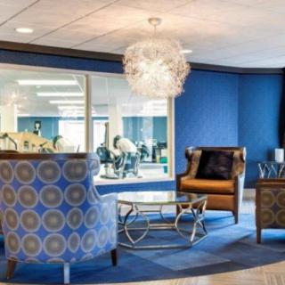 A modern office lounge area with stylish seating and contemporary lighting.