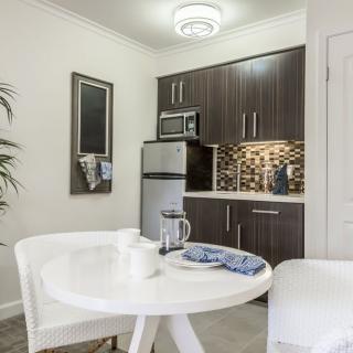 A modern apartment kitchen with a small dining area.