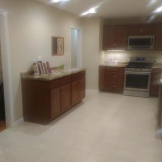 Modern kitchen with wooden cabinets and stainless steel appliances.