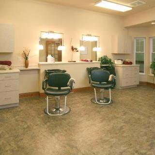 An interior view of a hair salon with two chairs and mirrors.