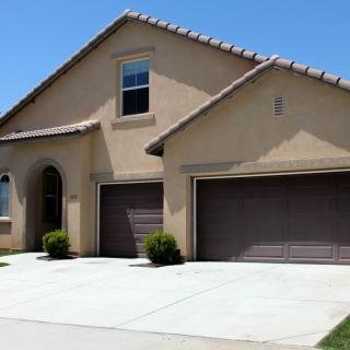 A modern suburban house with a double garage and a clean driveway.