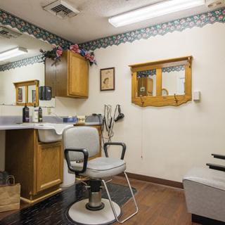 Cozy barber shop interior with a vintage chair and mirror setup.