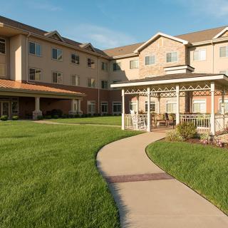 A well-maintained residential building with a garden and a winding pathway.