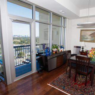 A modern dining area with large windows and a city view.