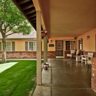 A welcoming porch leading to a cozy entrance surrounded by greenery.