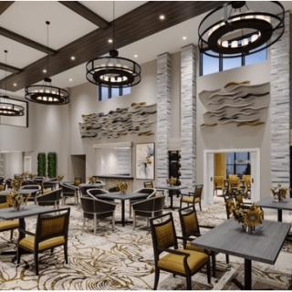 A spacious and elegantly designed dining area featuring modern chandeliers and stylish furniture.