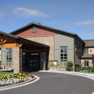 A modern building with a welcoming entrance and landscaped surroundings.
