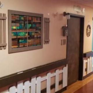 A hallway featuring colorful artwork and decorative elements on the walls.