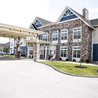 A residential building with a stone exterior and a covered entrance.