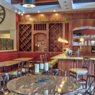 Cozy restaurant interior with a well-organized wine rack and inviting seating area.