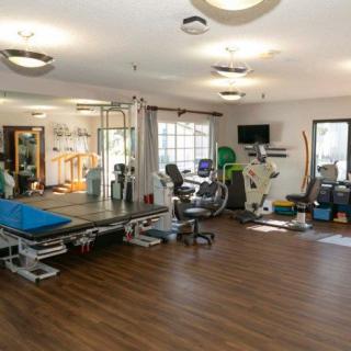 A well-equipped gym with various exercise machines and fitness equipment in a spacious area.