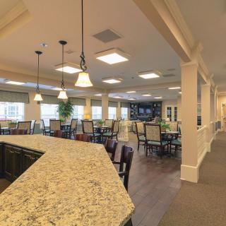 A modern dining area with a bar counter and elegant lighting.