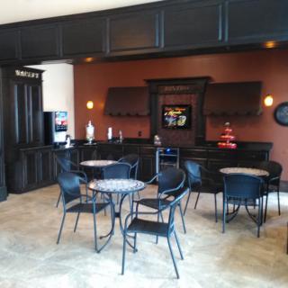 A modern cafe interior with tables and chairs arranged for seating.