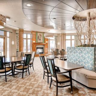 A modern dining area with a stylish fireplace and elegant seating arrangements.