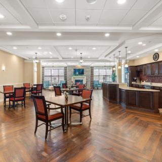 A spacious and elegant dining area with hardwood floors and modern furnishings.