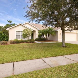 A suburban house with a well-maintained front yard and driveway.