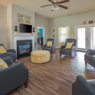 A modern living room with comfortable seating and a cozy fireplace.