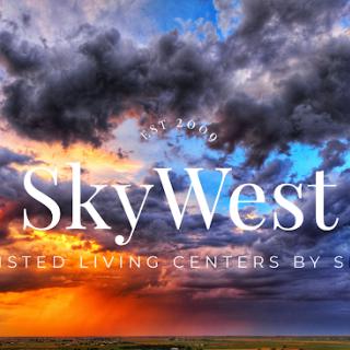 A stunning sunset captured over a dramatic sky with clouds, featuring the SkyWest logo.