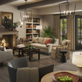 A cozy living room with a fireplace, comfortable seating, and elegant decor.