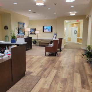 A comfortable and modern waiting room with seating, a television, and decor.