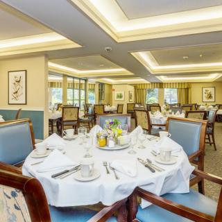 An elegantly set dining room with neatly arranged tables and chairs, creating a luxurious and inviting atmosphere.