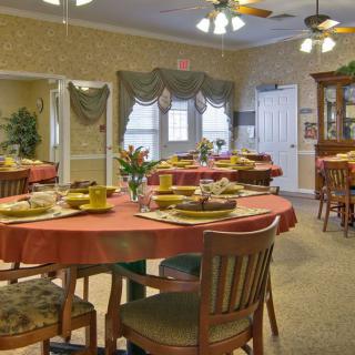 A warmly decorated dining room with tables set for a meal.