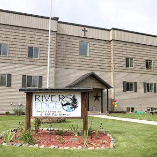 Exterior view of a building with a sign indicating 'River Edge'.