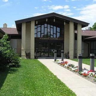 Entrance of a modern building with a landscaped pathway.