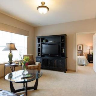 A cozy living room with modern furniture and a television.