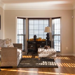 A cozy living room filled with natural light, showcasing modern furniture and elegant decor.