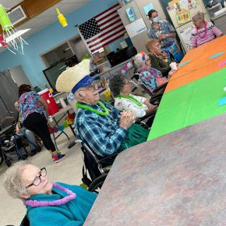 Seniors enjoying a vibrant community gathering with fun decorations and activities.