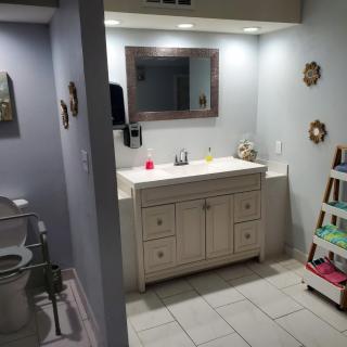 A tidy bathroom with a sink, mirror, and decorative elements.