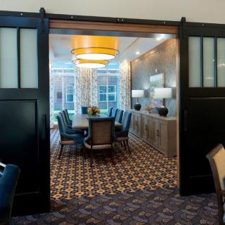 Elegant dining room with sliding doors and stylish decor.