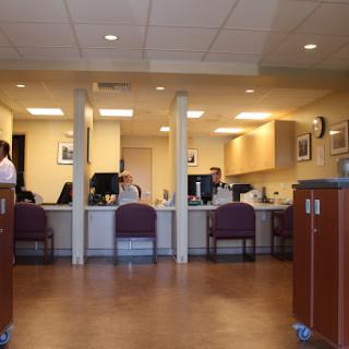 A view of a reception area in a healthcare facility with staff at the front desk.